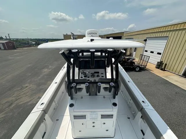 Slide: The Image of 2025 Sportsman 282 Open boat with Garmin equipment, docked near industrial buildings. - 12