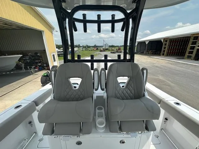 Slide: The Image of 2025 Sportsman 282 Open boat interior with two cushioned seats and rod holders. - 14