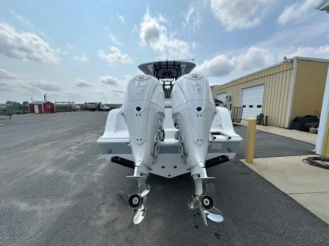 Slide: The Image of 2025 Sportsman 282 Open boat with twin outboard engines, parked outdoors on a sunny day. - 4