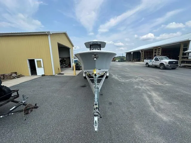 Slide: The Image of 2025 Sportsman 282 Open boat on trailer in industrial area, clear sky background. - 6