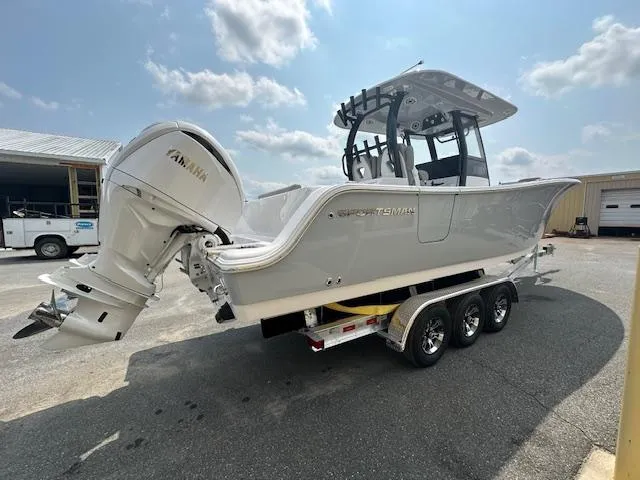 Slide: The Image of 2025 Sportsman 282 Open boat on trailer, featuring Yamaha outboard motor, parked outdoors. - 9