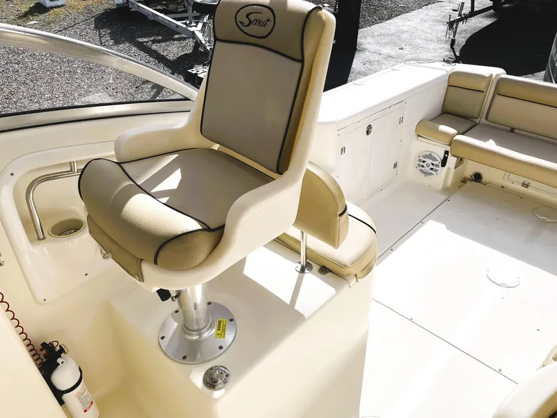 Slide: The Image of 2006 Scout 242 Abaco boat interior with beige seating and steering chair. - 11