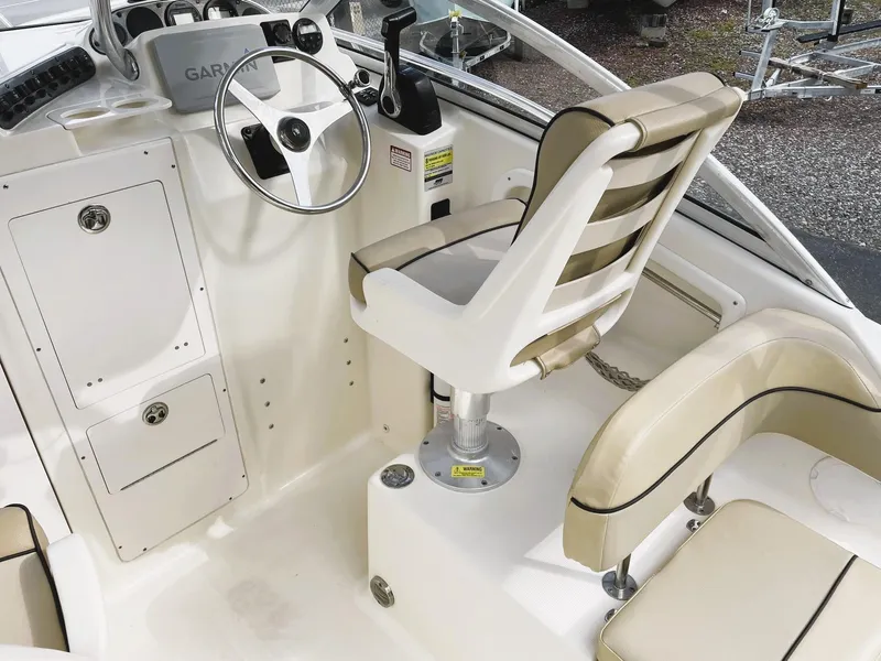Slide: The Image of 2006 Scout 242 Abaco boat interior with steering wheel and seating. - 12
