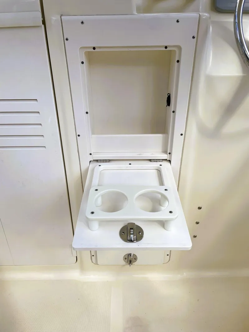 Slide: The Image of 2006 Scout 242 Abaco boat cup holder and storage compartment. - 15