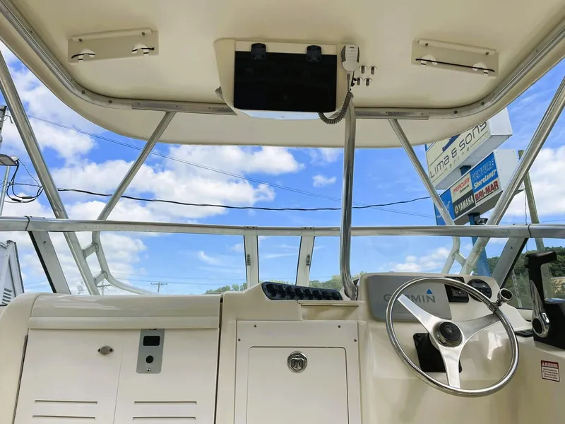 Slide: The Image of Interior view of 2006 Scout 242 Abaco boat cockpit with steering wheel and controls. - 16