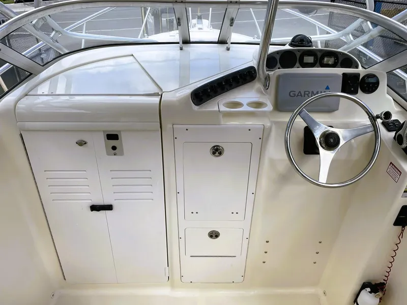 Slide: The Image of 2006 Scout 242 Abaco boat dashboard with steering wheel and controls. - 17