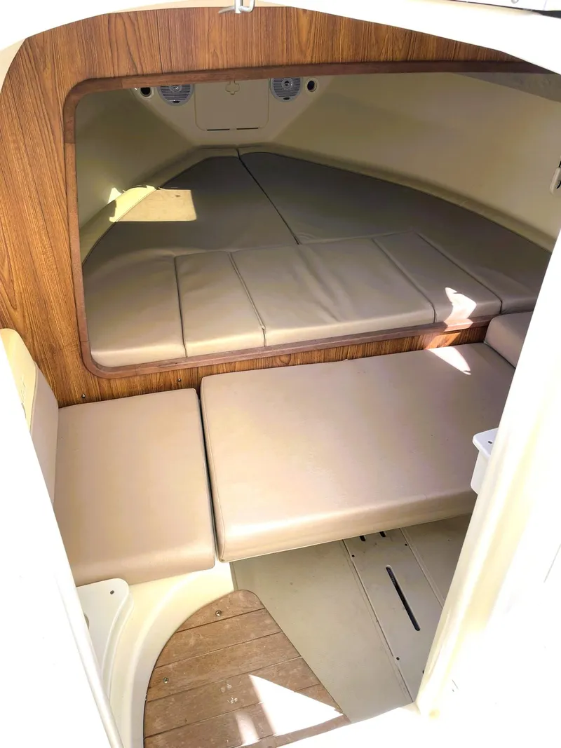 Slide: The Image of 2006 Scout 242 Abaco cabin interior with cushioned seating and wood accents. - 19