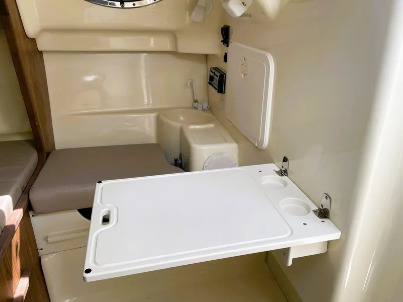Slide: The Image of 2006 Scout 242 Abaco cabin interior with foldable table and seating area. - 20