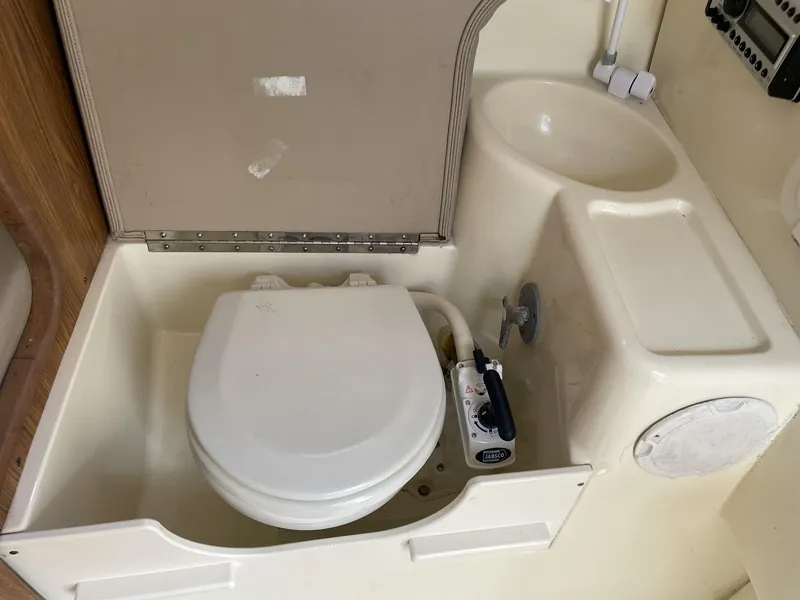 Slide: The Image of 2006 Scout 242 Abaco boat bathroom with toilet and sink. - 21
