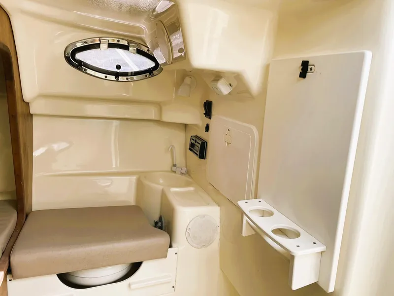 Slide: The Image of Interior of 2006 Scout 242 Abaco boat cabin with seating and porthole. - 22