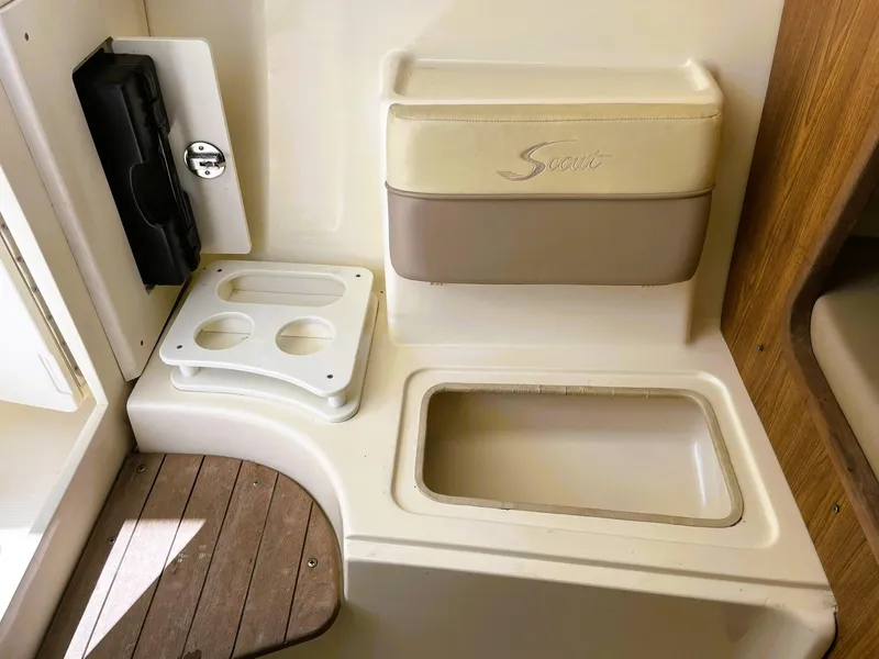 Slide: The Image of 2006 Scout 242 Abaco boat interior with storage and cup holders. - 24