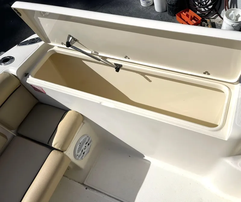 Slide: The Image of Open storage compartment on 2006 Scout 242 Abaco boat, with beige seating and speaker. - 6