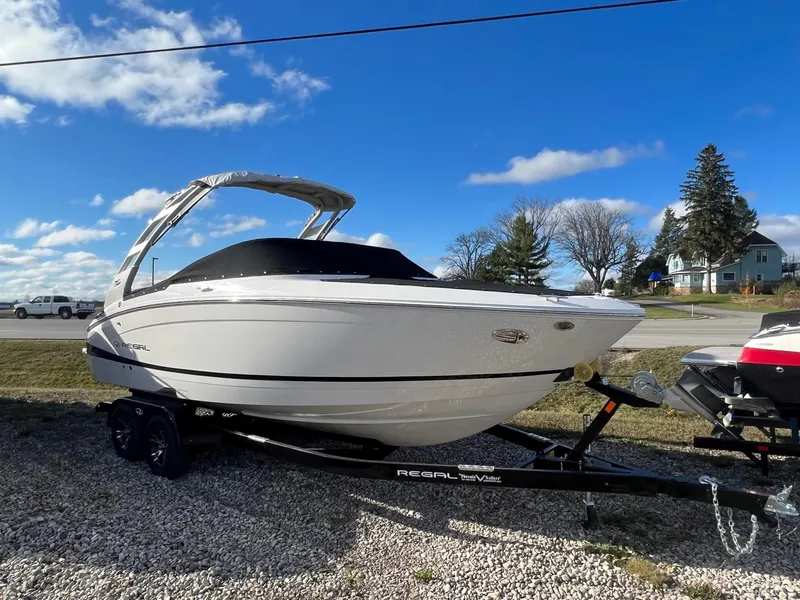 The Image of 2025 Regal LS4 boat on trailer under blue sky. - 0