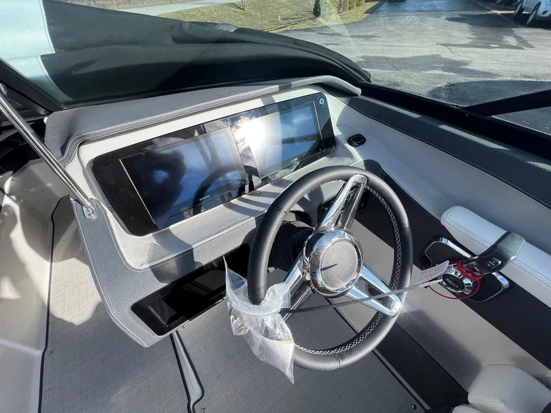 Slide: The Image of 2025 Regal LS4 boat dashboard with modern steering wheel and touchscreen display. - 11