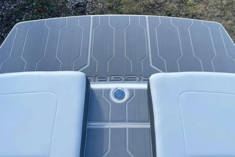Slide: The Image of 2025 Regal LS4 boat deck with sleek gray and white design. - 12