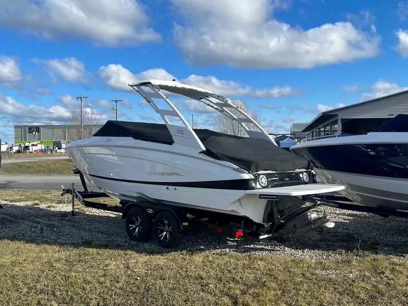 Slide: The Image of 2025 Regal LS4 boat on trailer under blue sky. - 3