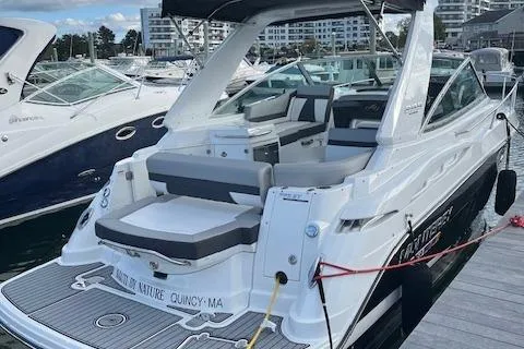 Slide: The Image of 2021 Monterey 295 Sport Yacht docked at marina, featuring sleek design and spacious seating. - 10