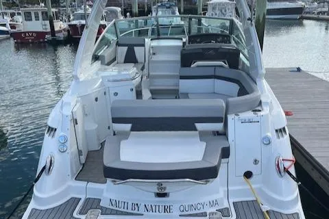 Slide: The Image of 2021 Monterey 295 Sport Yacht docked, featuring spacious seating and sleek design. - 12