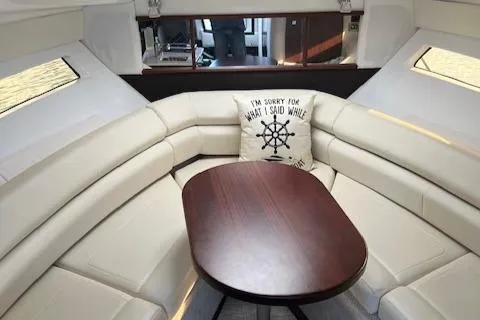 Slide: The Image of Luxurious interior of 2021 Monterey 295 Sport Yacht with plush seating and wooden table. - 18