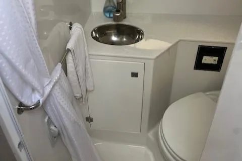 Slide: The Image of 2021 Monterey 295 Sport Yacht bathroom with sink, toilet, and towel rack. - 3