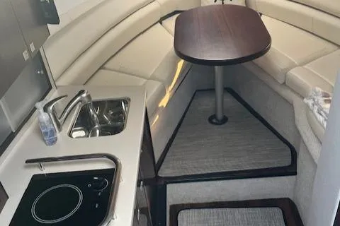 Slide: The Image of Interior of 2021 Monterey 295 Sport Yacht with kitchenette and seating area. - 4