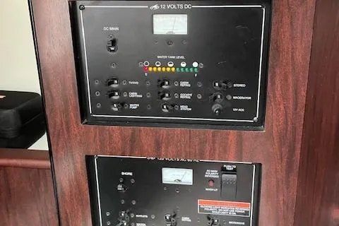 Slide: The Image of Control panel of 2021 Monterey 295 Sport Yacht, featuring switches and gauges. - 6