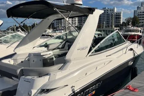 Slide: The Image of 2021 Monterey 295 Sport Yacht docked at marina with cityscape background. - 7