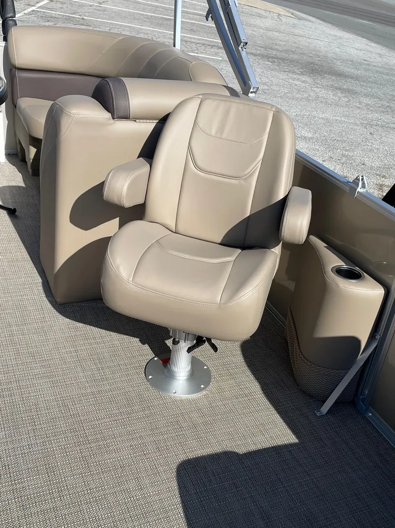 Slide: The Image of 2025 Sylvan 820 Mirage Cruise boat interior with beige captain's chair and cup holder. - 11
