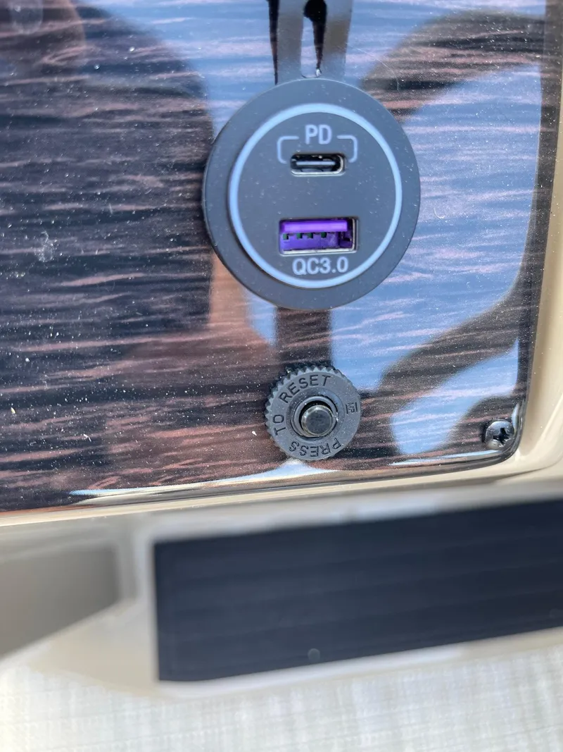 Slide: The Image of USB charging ports on 2025 Sylvan 820 Mirage Cruise dashboard. - 23