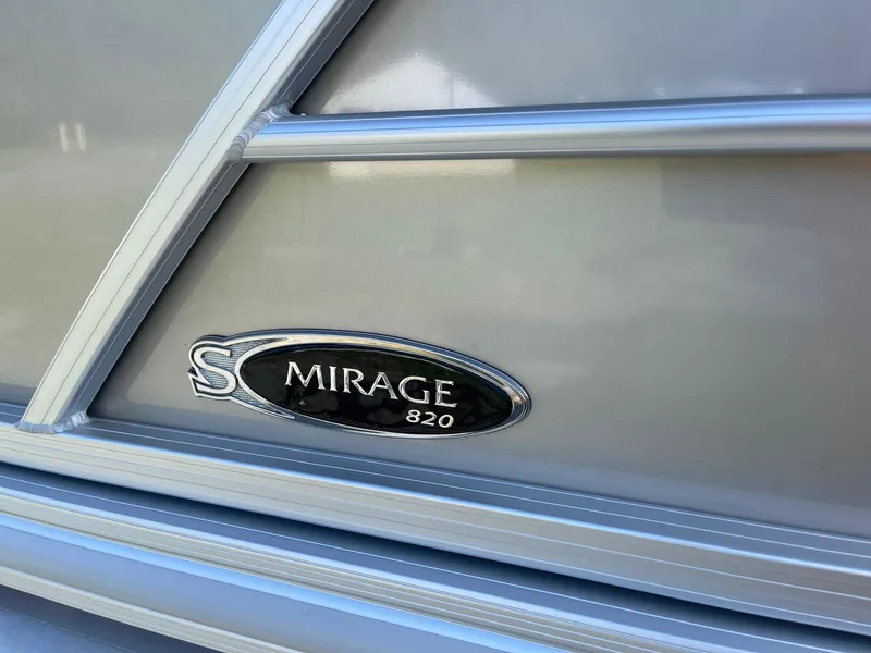 Slide: The Image of 2025 Sylvan 820 Mirage Cruise boat emblem on metallic surface. - 4