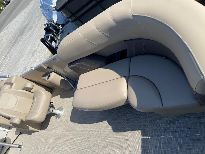 Slide: The Image of 2025 Sylvan 820 Mirage Cruise boat interior with beige seating and carpet flooring. - 6