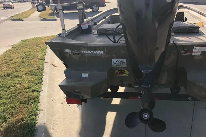 Slide: The Image of 2022 Tracker Grizzly 1860 CC boat with motor on a sunny street. - 10