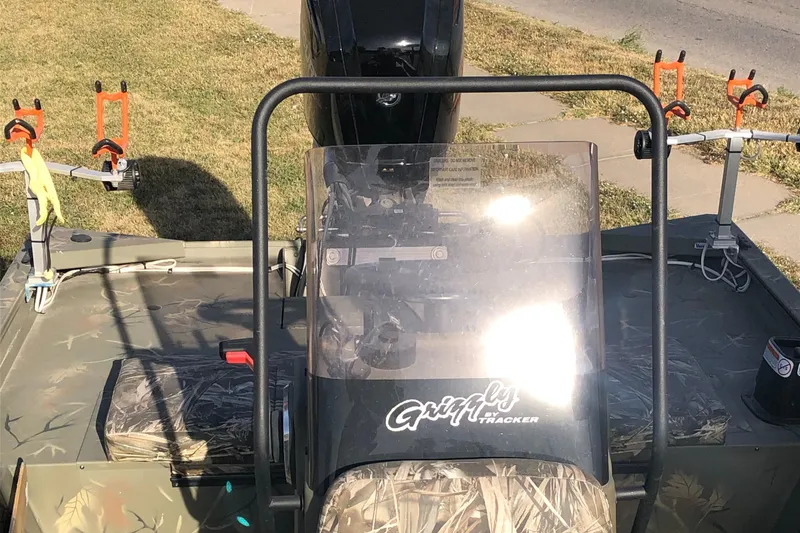 Slide: The Image of 2022 Tracker Grizzly 1860 CC boat with camouflage seating and fishing rod holders. - 13