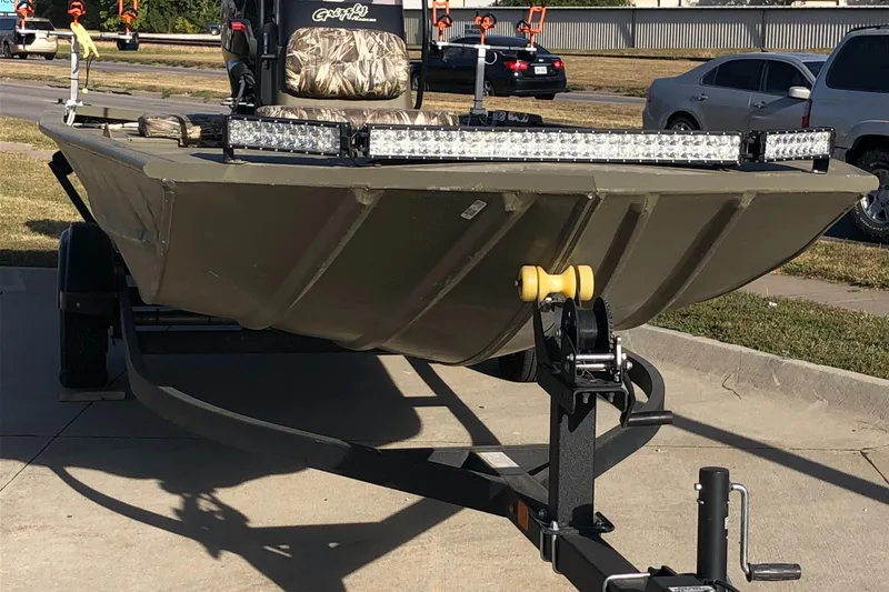 Slide: The Image of 2022 Tracker Grizzly 1860 CC boat on trailer, parked outdoors. - 14