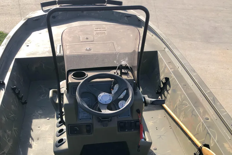 Slide: The Image of 2022 Tracker Grizzly 1860 CC boat interior with steering console and controls. - 5