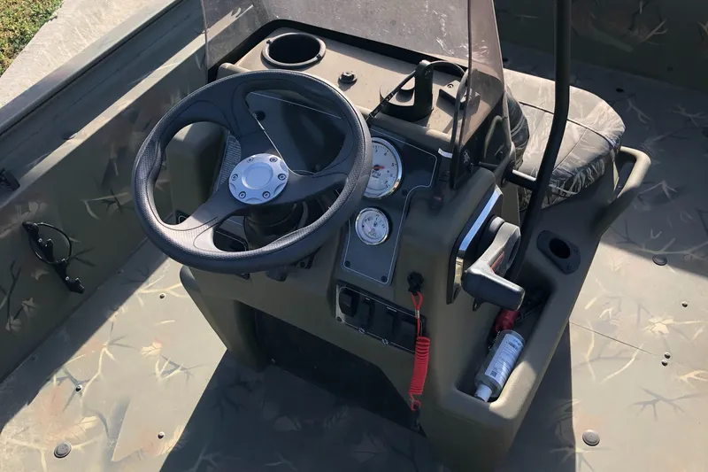 Slide: The Image of 2022 Tracker Grizzly 1860 CC boat console with steering wheel and gauges. - 6