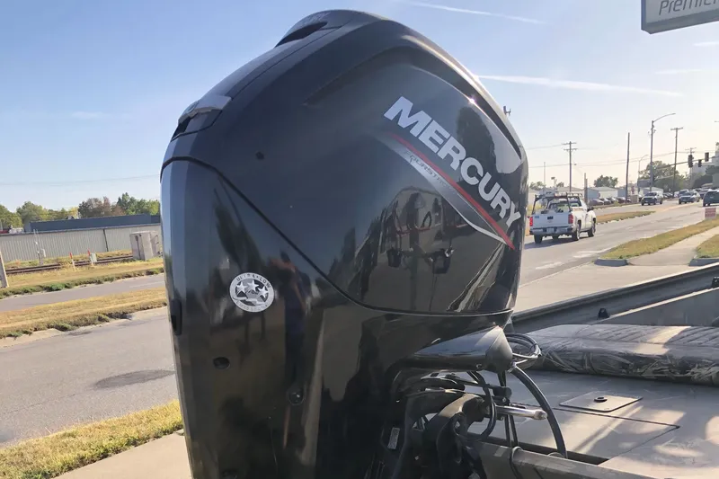Slide: The Image of 2022 Tracker Grizzly 1860 CC with Mercury outboard motor on a sunny street. - 7