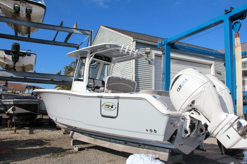 Slide: The Image of 2025 Sea Hunt Ultra 265 SE boat with Yamaha engine in storage yard. - 14