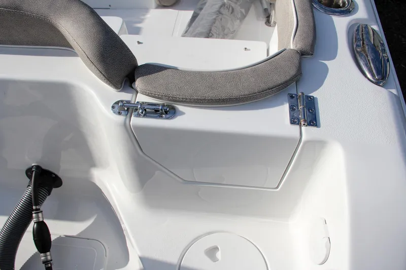 Slide: The Image of 2025 Sea Hunt Ultra 265 SE boat interior with cushioned seating and stainless steel fixtures. - 15
