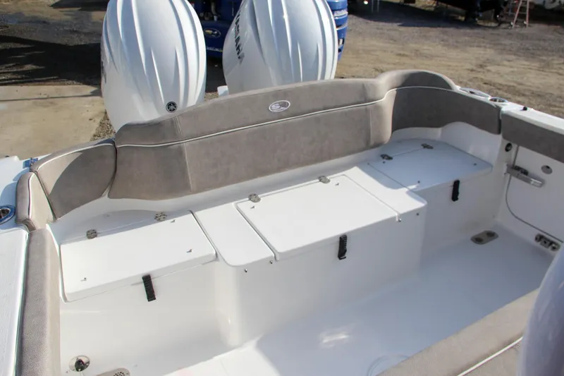 Slide: The Image of 2025 Sea Hunt Ultra 265 SE boat interior with cushioned seating and storage compartments. - 16