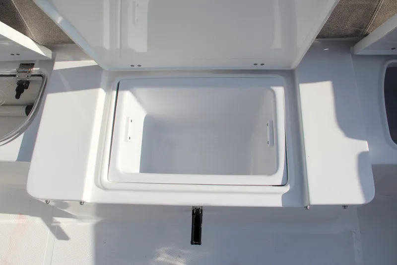 Slide: The Image of 2025 Sea Hunt Ultra 265 SE boat storage compartment, open and empty. - 19