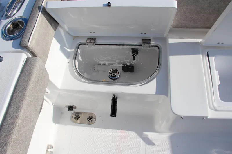 Slide: The Image of 2025 Sea Hunt Ultra 265 SE boat interior with open storage compartment. - 20