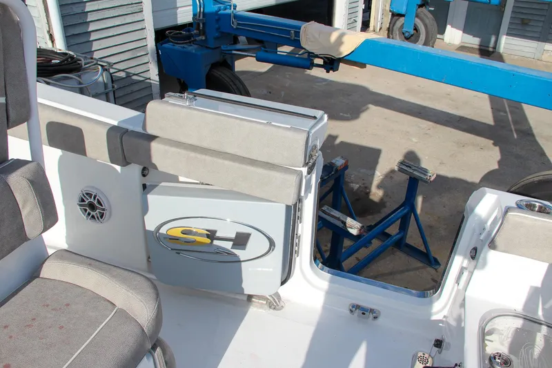 Slide: The Image of 2025 Sea Hunt Ultra 265 SE boat interior with seating and storage. - 23