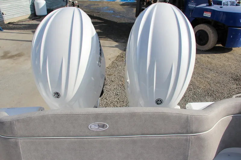 Slide: The Image of 2025 Sea Hunt Ultra 265 SE with dual outboard engines, rear view. - 26