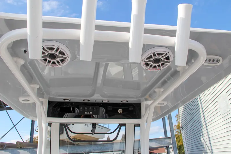 Slide: The Image of 2025 Sea Hunt Ultra 265 SE boat roof with speakers and rod holders. - 27