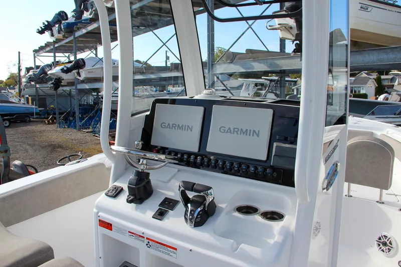 Slide: The Image of 2025 Sea Hunt Ultra 265 SE boat dashboard with dual Garmin displays. - 28