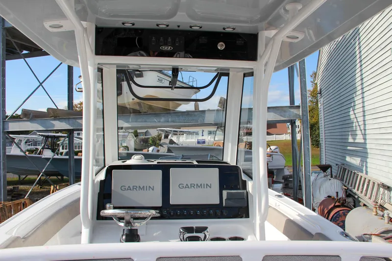 Slide: The Image of 2025 Sea Hunt Ultra 265 SE boat dashboard with dual Garmin displays. - 3