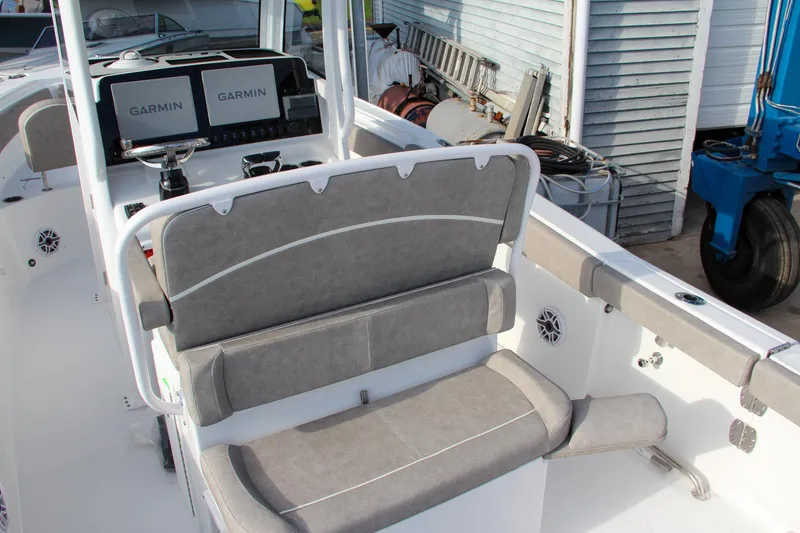 Slide: The Image of 2025 Sea Hunt Ultra 265 SE boat interior with Garmin displays and cushioned seating. - 34