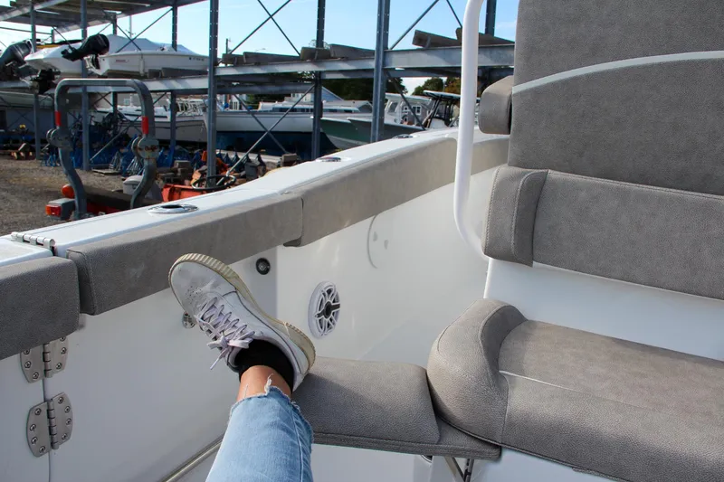 Slide: The Image of Person relaxing on a 2025 Sea Hunt Ultra 265 SE boat in a marina. - 35