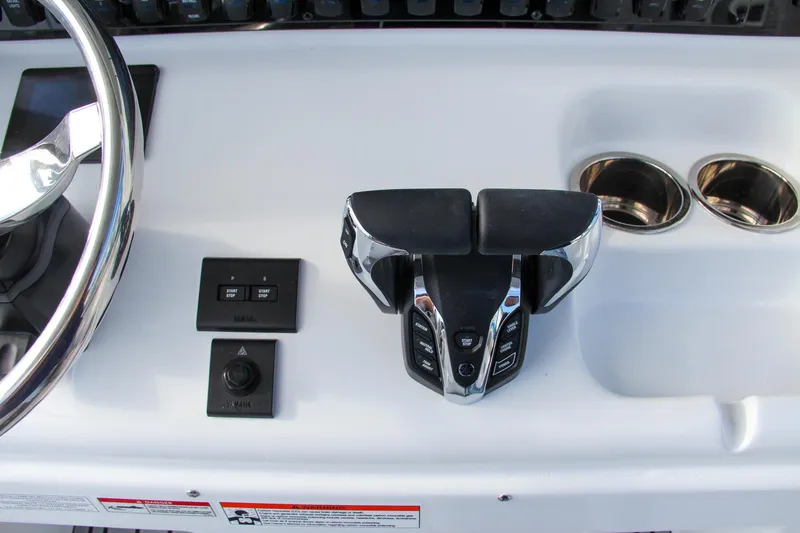 Slide: The Image of 2025 Sea Hunt Ultra 265 SE boat controls and steering wheel. - 45